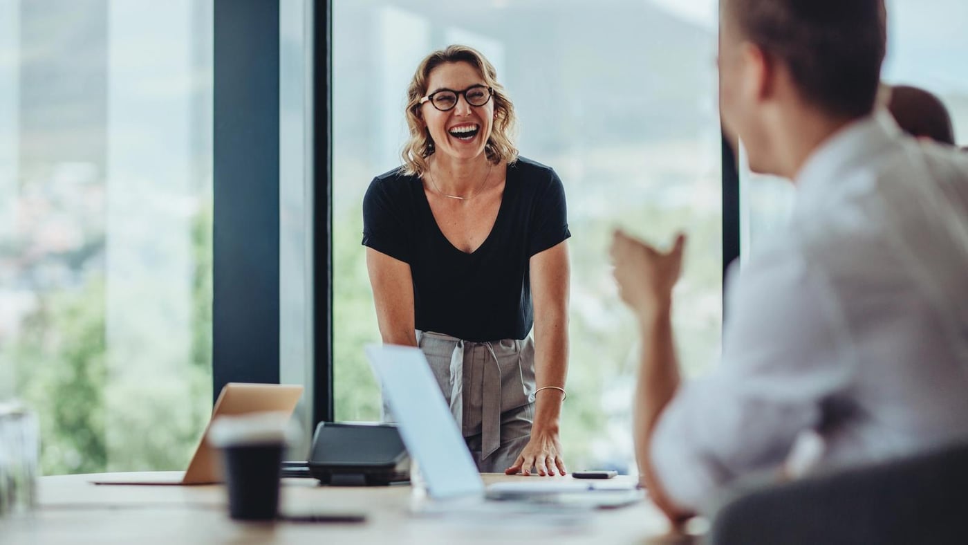 A smiling business women in a bright modern office.